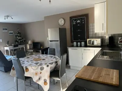 a kitchen and dining room with a table and a kitchen with a christmas tree at Gîte Au Coeur Du Pays Cathare in Fanjeaux