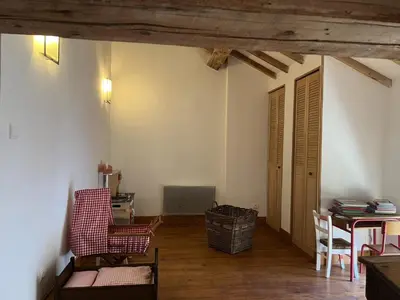 an empty living room with a table and chairs at Bienvenue à l'école des garçons ! in Ouveillan