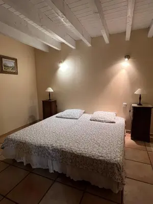 a bedroom with a bed with two pillows on it at Bienvenue à l'école des garçons ! in Ouveillan
