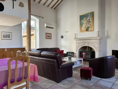 a living room with a couch and a fireplace at Bienvenue à l'école des garçons ! in Ouveillan
