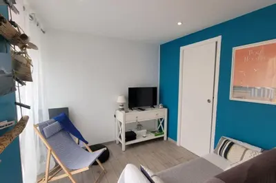 a living room with blue walls and a couch and chairs at Lo Cabanot maison de pêcheur pour 4 in Port-la-Nouvelle