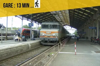 a train on the tracks at a train station at Le Gite Vegetal Cite Wifi Machine a laver 2 personnes in Carcassonne