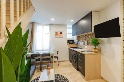 a kitchen with a sink and a stove top oven at Le Gite Vegetal Cite Wifi Machine a laver 2 personnes in Carcassonne