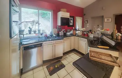 a kitchen with a sink and a dishwasher at Un Veritable Havre De Paix in Roquebrun