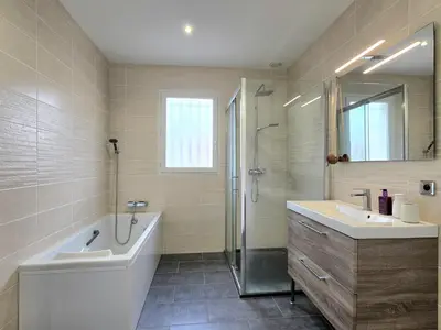 a bathroom with a tub and a sink and a shower at Grande maison familiale, spacieuse et confortable in Espira-de-lʼAgly