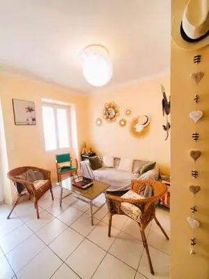 a living room with a couch and a table at La Sigeannaise belle maison près des plages in Sigean