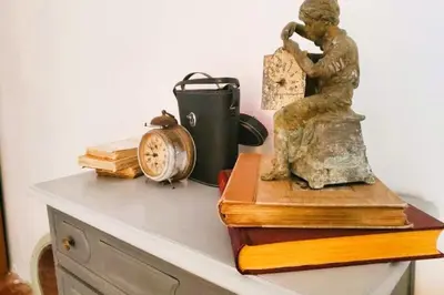 a statue sitting on top of a table with books at La Sigeannaise belle maison près des plages in Sigean