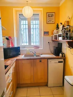 a kitchen with a sink and a window at La Sigeannaise belle maison près des plages in Sigean