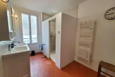 a bathroom with a sink and a mirror at La Sigeannaise belle maison près des plages in Sigean