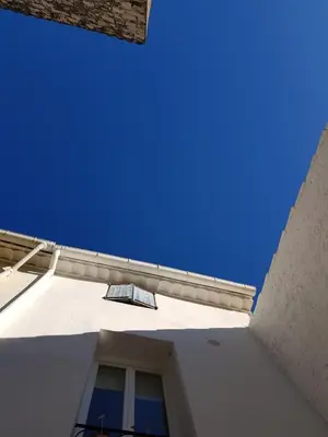 a white building with a window and a blue sky at La Sigeannaise belle maison près des plages in Sigean