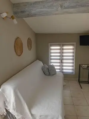 a bedroom with a white bed and a window at Studio Corneille -Climatisation WIFI Vue in Narbonne