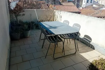a blue table and chairs sitting on a patio at Studio Corneille -Climatisation WIFI Vue in Narbonne