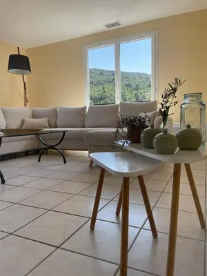 a living room with a couch and a table at Les hauts d'Embres havre de paix pour 8 in Embres-et-Castelmaure