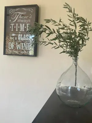 a glass vase with a plant in it on a table at Les hauts d'Embres havre de paix pour 8 in Embres-et-Castelmaure