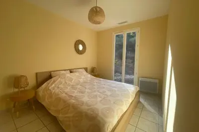 a bedroom with a bed and a window at Les hauts d'Embres havre de paix pour 8 in Embres-et-Castelmaure