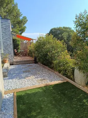 a backyard with a garden and a patio at Studio terrasse au calme près de Narbonne in Montredon