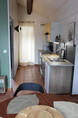 a kitchen with a sink and a counter top at La petite maison in Cuxac-Cabardès