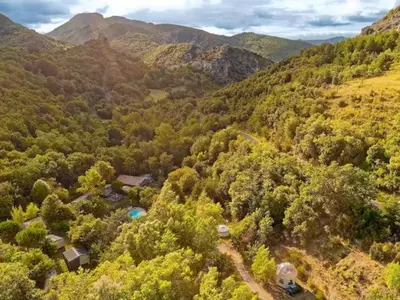 an aerial view of a forest with a house and mountains at Mobil home 6 pers avec terrasse à Fenouillet - API-1-52-314 in Fenouillet