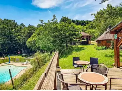a deck with tables and chairs next to a pool at Mobil home 6 pers avec terrasse à Fenouillet - API-1-52-314 in Fenouillet