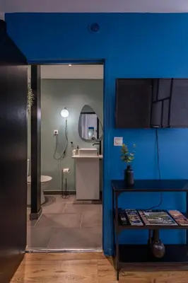 a blue bathroom with a sink and a mirror at L'indigo - Studio Apaisant et Lumineux, Hyper centre in Castres