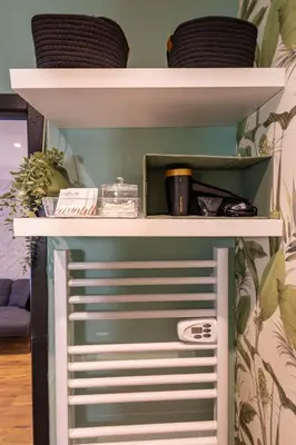 a shelf in a room with some dishes on it at L'indigo - Studio Apaisant et Lumineux, Hyper centre in Castres