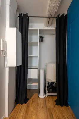a closet with black curtains in a room at L'indigo - Studio Apaisant et Lumineux, Hyper centre in Castres