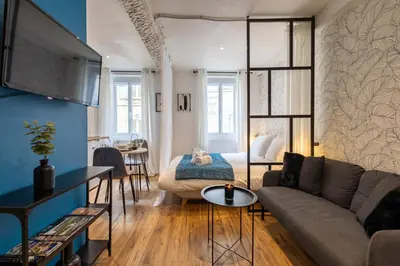 a living room with a couch and a table at L'indigo - Studio Apaisant et Lumineux, Hyper centre in Castres
