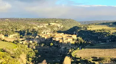 a rainbow in the sky over a mountain valley at Maison entre mer et montagne in Cassagnolles
