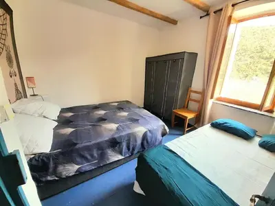 a bathroom with a sink and a wooden floor at Maison entre mer et montagne in Cassagnolles