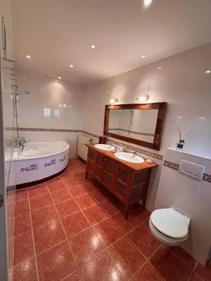 a bathroom with a tub and a sink and a toilet at Domaine de Hauterive in Pont-de-Larn