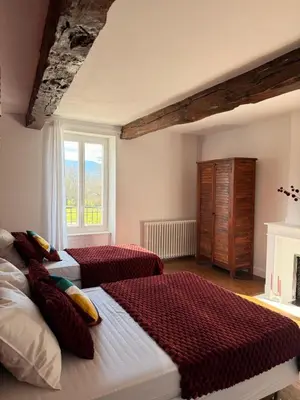 a bedroom with two beds and a window at Domaine de Hauterive in Pont-de-Larn