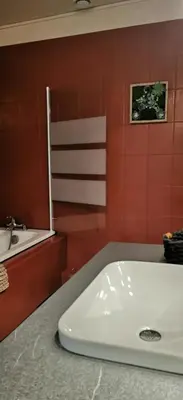 a bathroom with a white sink and a counter at la chambre gourmande, en Richard in Auriac-sur-Vendinelle