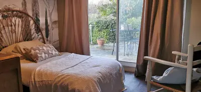 a bedroom with a bed and a large window at la chambre gourmande, en Richard in Auriac-sur-Vendinelle