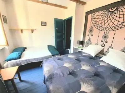 a bedroom with a bed in a room at Maison au pied de la Montagne Noire proche Carcassonne in Cassagnolles
