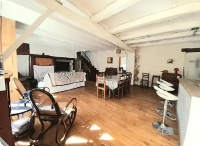 a large living room with a table and chairs at Maison au pied de la Montagne Noire proche Carcassonne in Cassagnolles