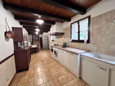 a kitchen with a sink and a counter top at Grand gîte proche des lacs in Prémian