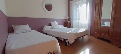 a hotel room with two beds and a window at Grand gîte proche des lacs in Prémian