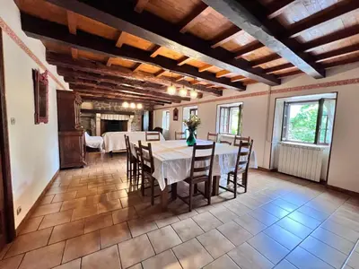 a dining room with a table and chairs at Grand gîte proche des lacs in Prémian