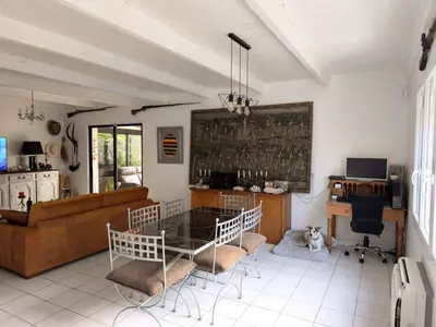 a living room with a glass table and chairs at La 1848 Narbonnaise in Narbonne
