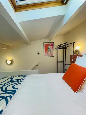 a bedroom with a large white bed in a room at Maison Franz - 800m des Grands Buffets - Garage in Narbonne