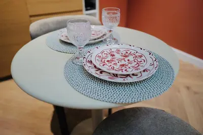 a white table with two plates and glasses on it at Maison Franz - 800m des Grands Buffets - Garage in Narbonne