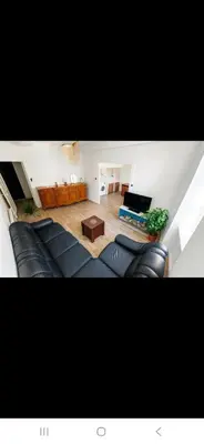 a living room with a couch and a table at Appartement avec deux chambres et salon de massage in Lavelanet