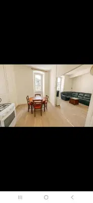 a kitchen and dining room with a table and chairs at Appartement avec deux chambres et salon de massage in Lavelanet