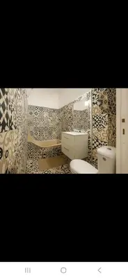 a bathroom with two toilets and a sink at Appartement avec deux chambres et salon de massage in Lavelanet