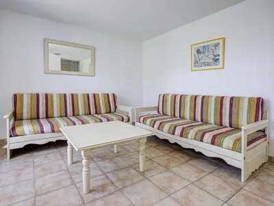 a living room with two couches and a table at P Minervois L N02 Villa 3P6 in Homps