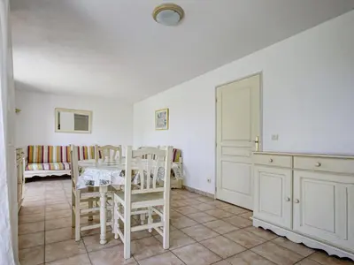 a kitchen with a table and chairs in a room at P Minervois L N02 Villa 3P6 in Homps