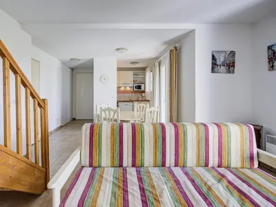 a living room with a couch and a table at P Minervois S N06 Villa 4P8 in Homps