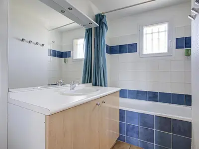 a bathroom with a sink and a tub at P Minervois S N06 Villa 4P8 in Homps