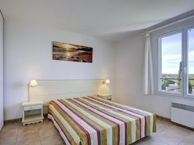 a white bedroom with a bed and a window at P Minervois S N06 Villa 4P8 in Homps