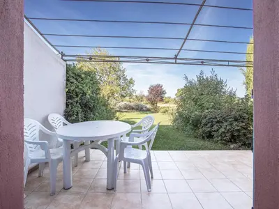 a white table and chairs on a patio at P Minervois P N05 Villa 2P4 in Homps